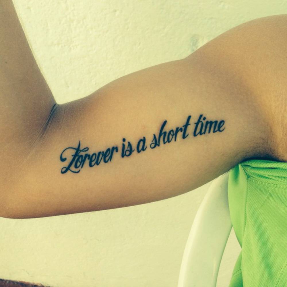 "Forever is a short time" tattoo on Angel Masero's inner arm.