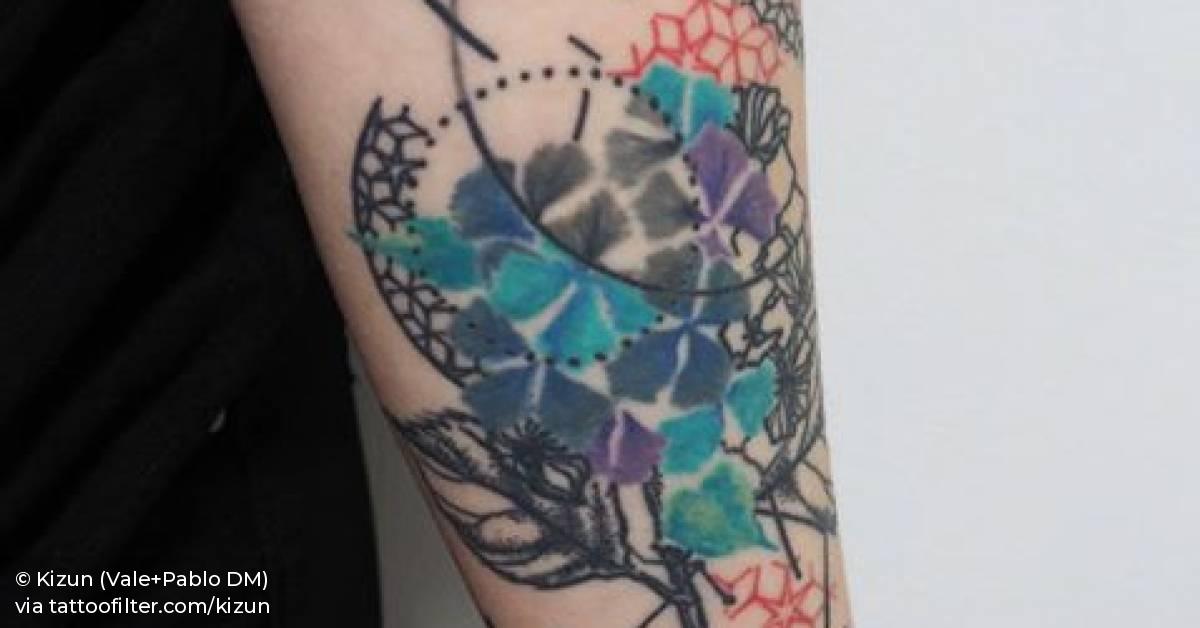 Abstract graphic piece on Cecile's left inner forearm.