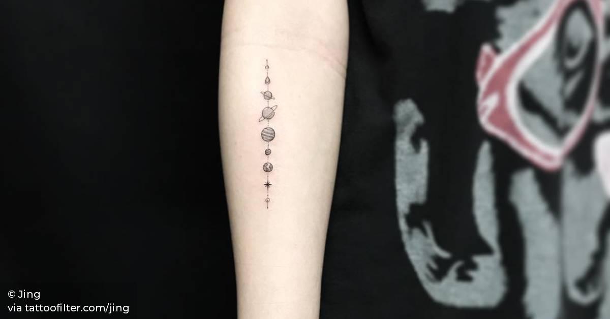 Solar system tattoo on the inner forearm.
