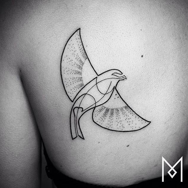 Continuous line bird tattoo on the left shoulder blade.