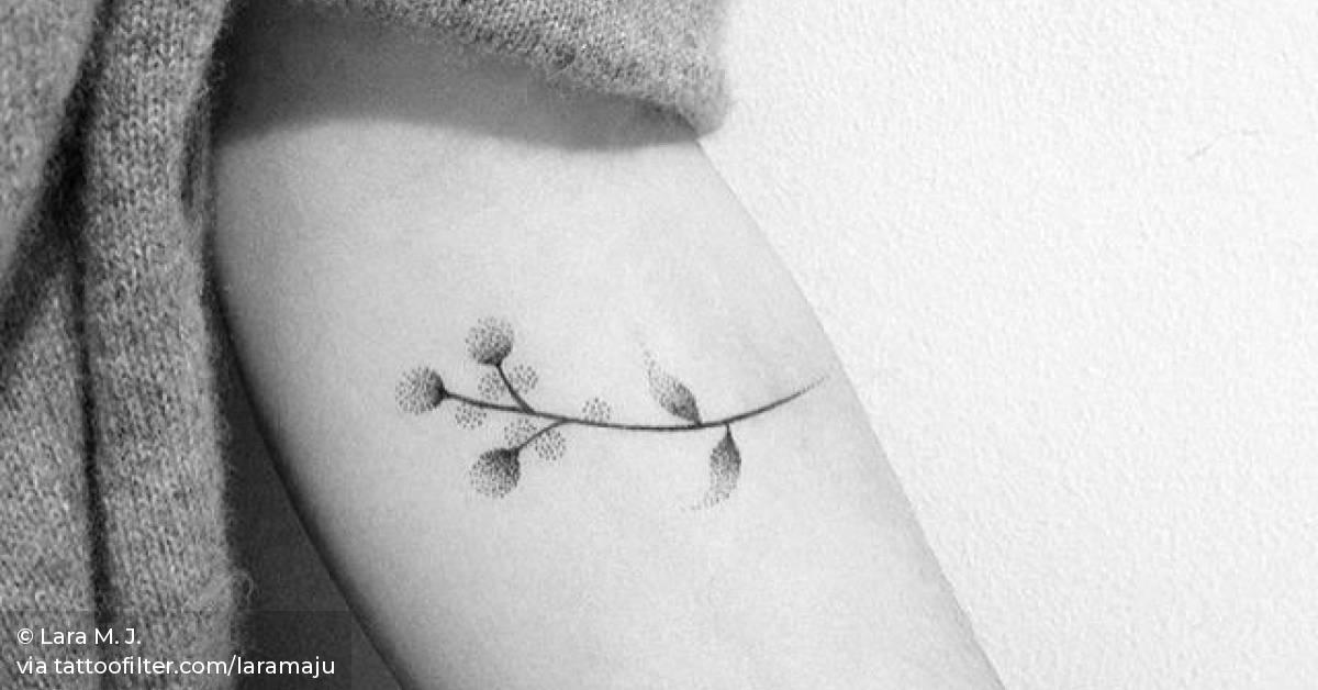 Hand poked flower tattoo on the left inner forearm.