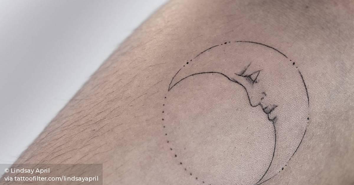 Fine line moon tattoo on the right inner forearm.