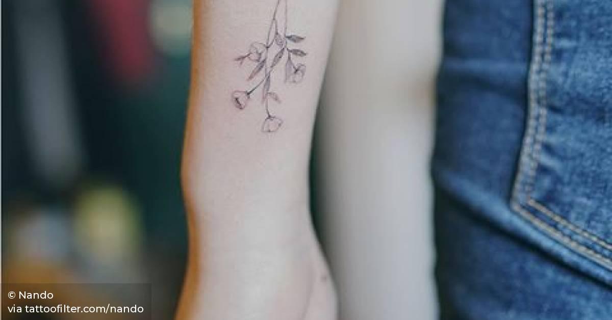 Fine line flower tattoos on the left wrist.
