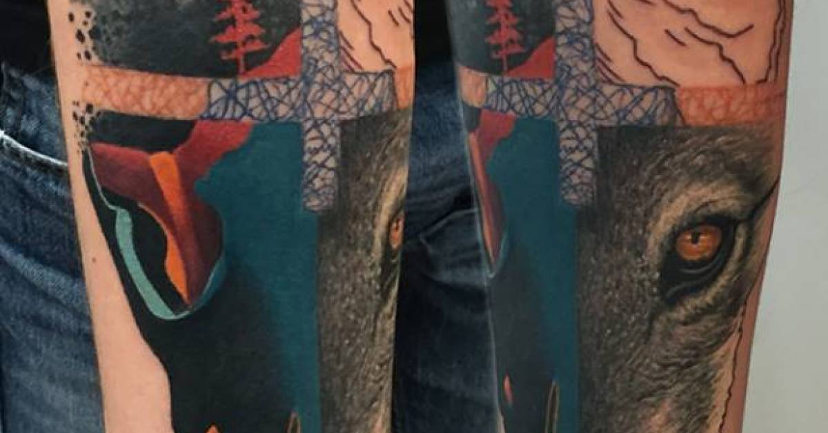 Graphic wolf and raven tattoo.