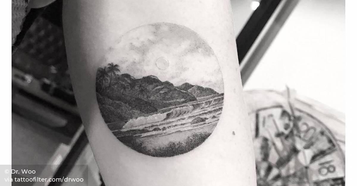 Heavenly landscape circle tattoo on the inner arm.