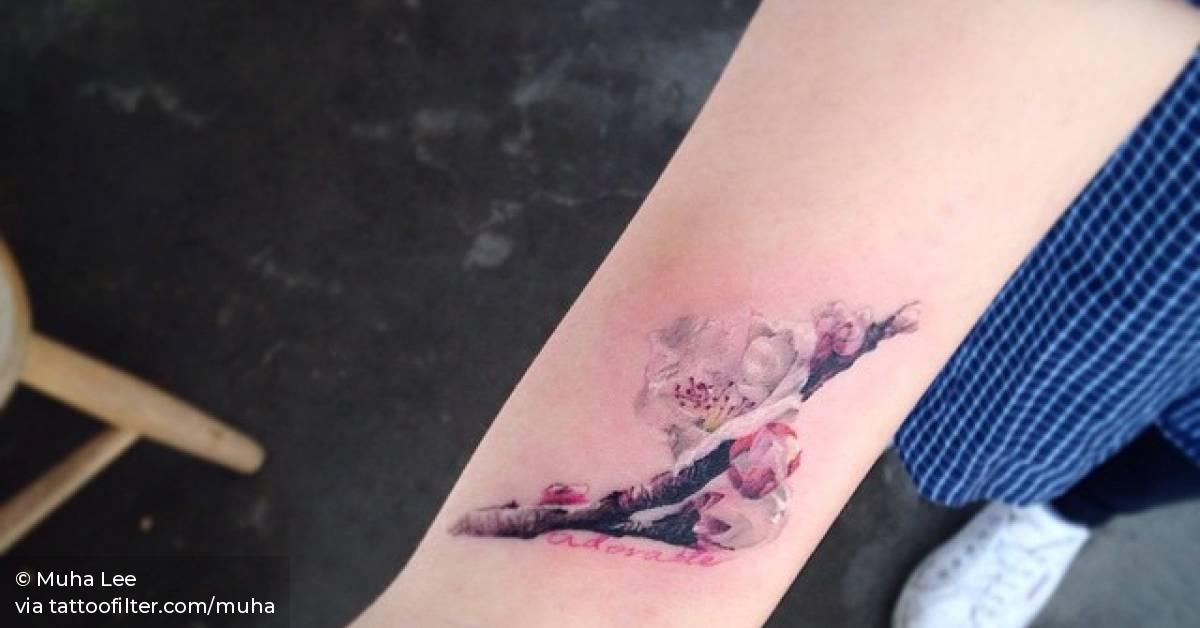 Realistic apricot blossoms on the right inner wrist.