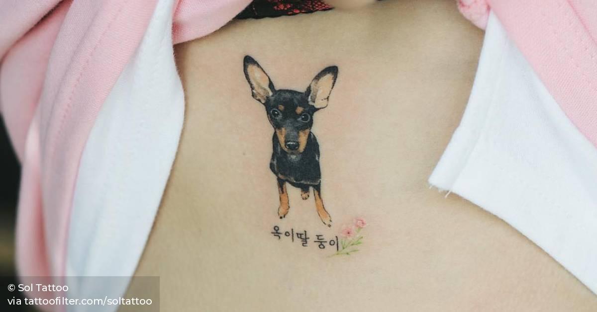 Pinscher tattoo on the left ribcage.
