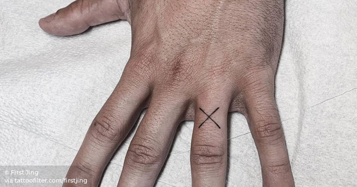 X letter tattoo on the left ring finger.