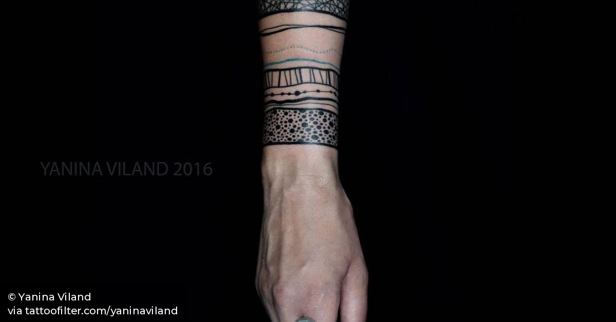 Ornamental armbands on the forearm.