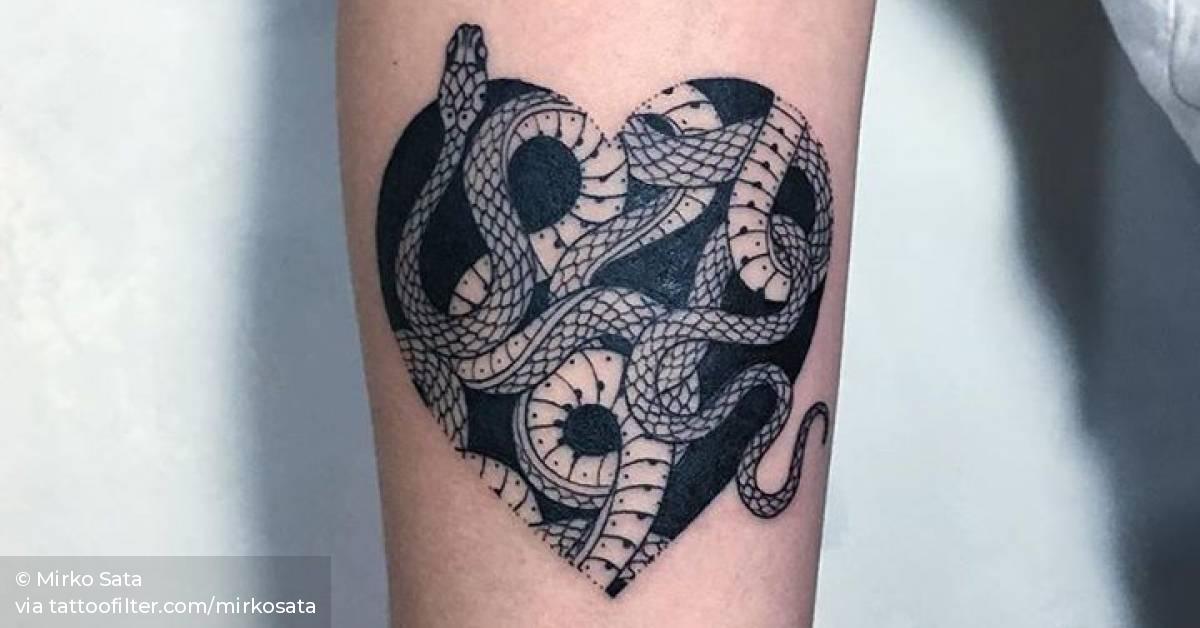 Snake heart tattoo on the inner forearm.