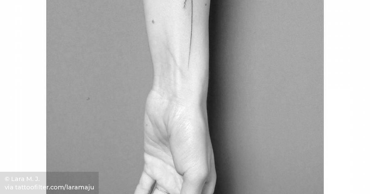 Hand poked palm tree tattoo on the inner forearm.