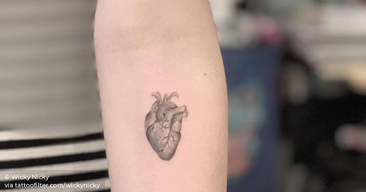 Anatomical heart tattoo on the inner forearm.