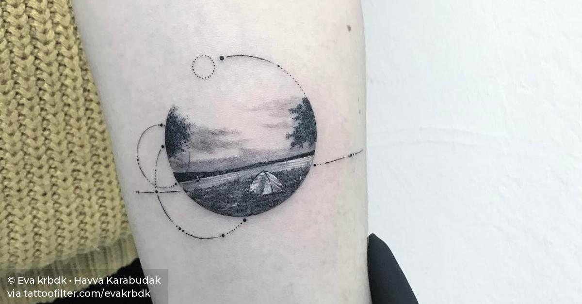 Landscape circle tattoo on the left inner forearm.