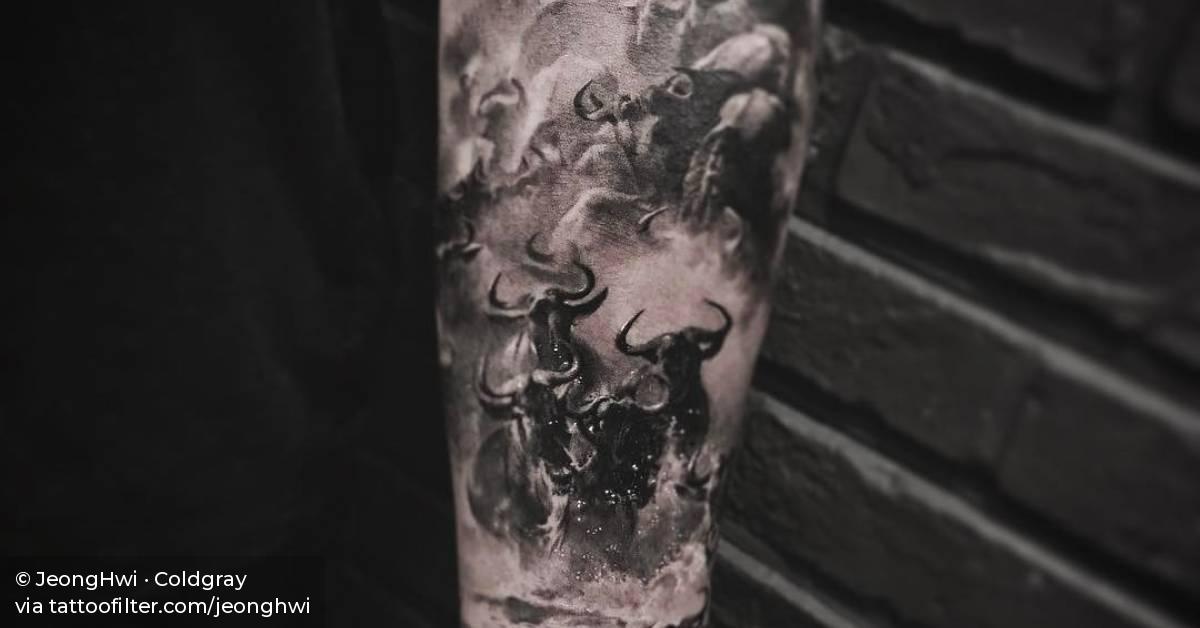 Buffalo herd running in water tattoo on the left inner