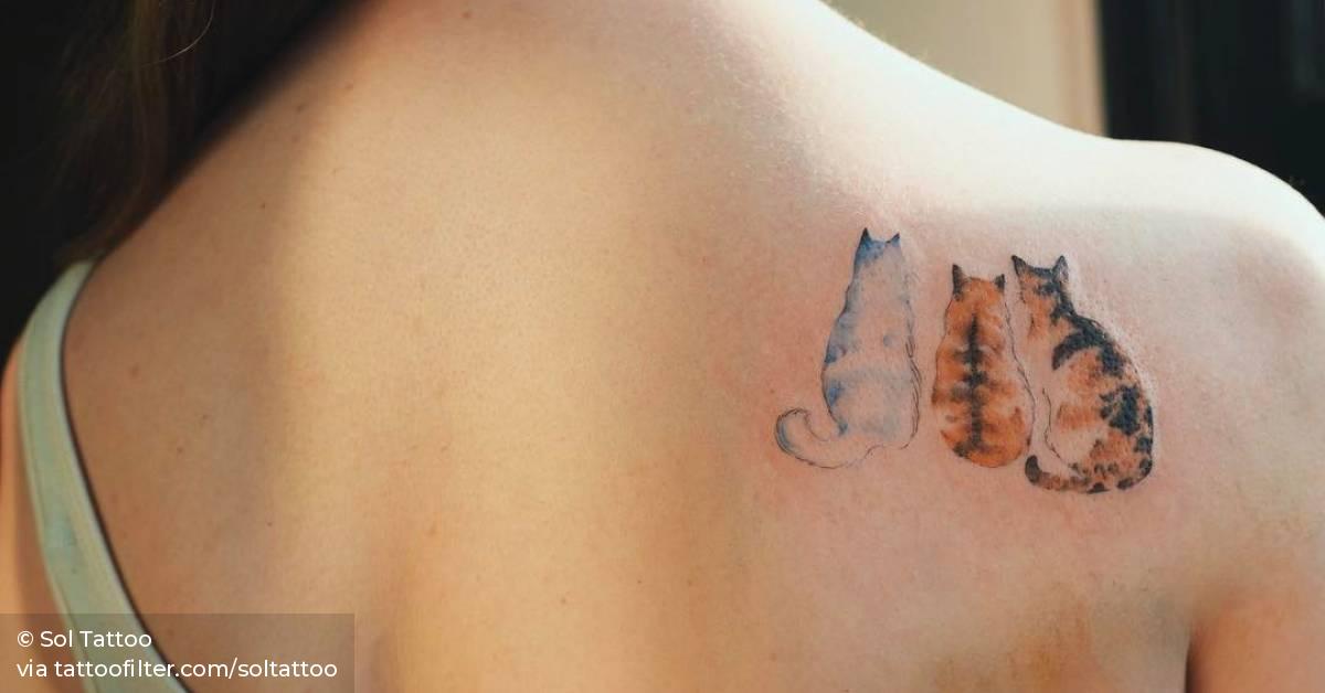 Three cats on the right shoulder blade.
