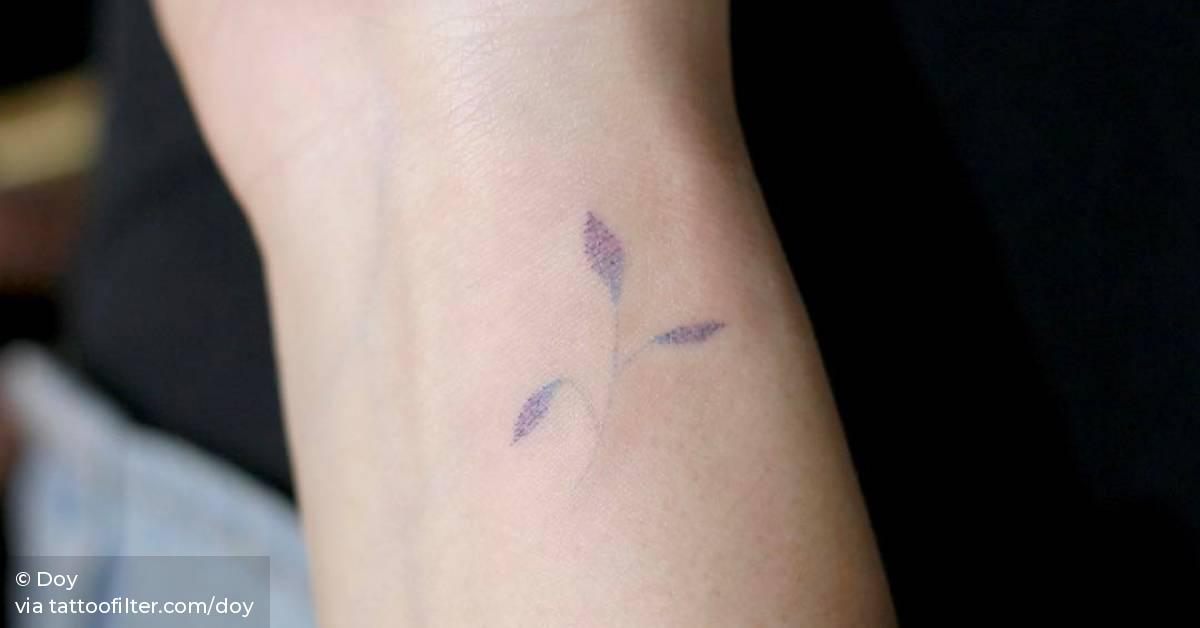 Hand poked flower tattoo on the inner wrist.