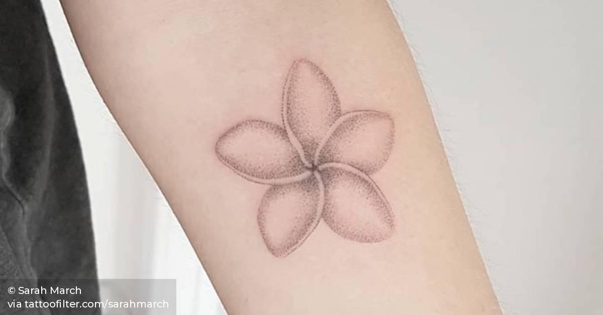 Hand poked frangipani tattoo on the inner forearm.