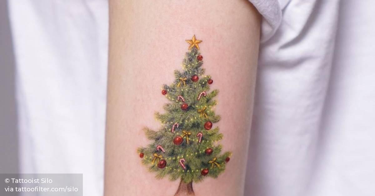 Christmas tree tattoo on the upper arm.