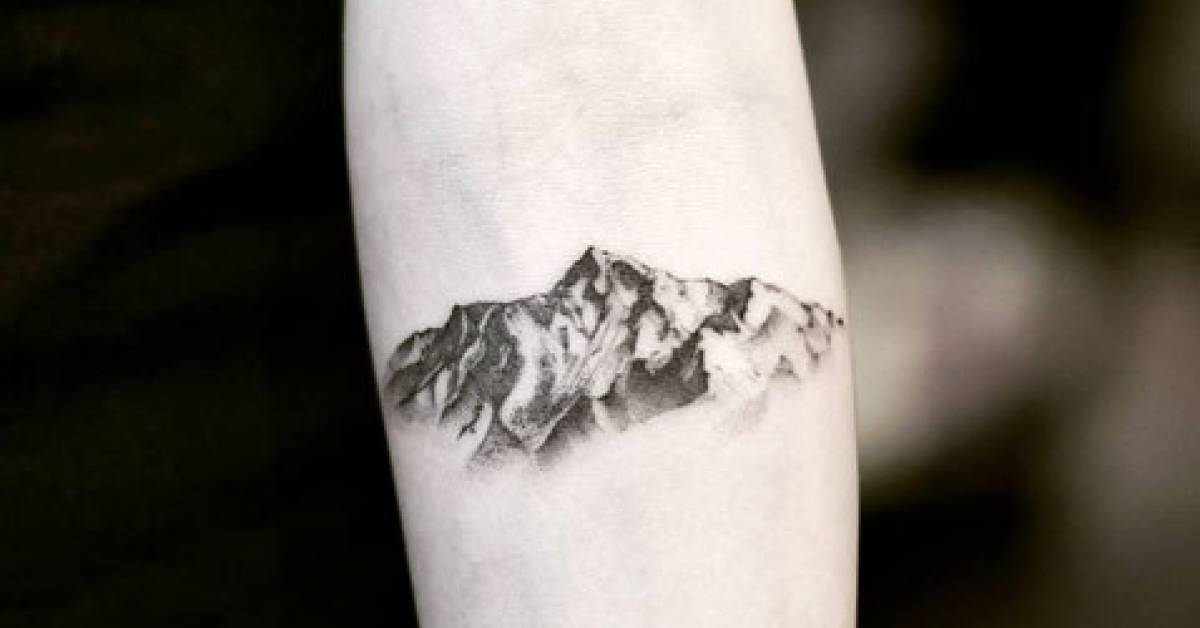 Mountain tattoo on the left inner forearm.