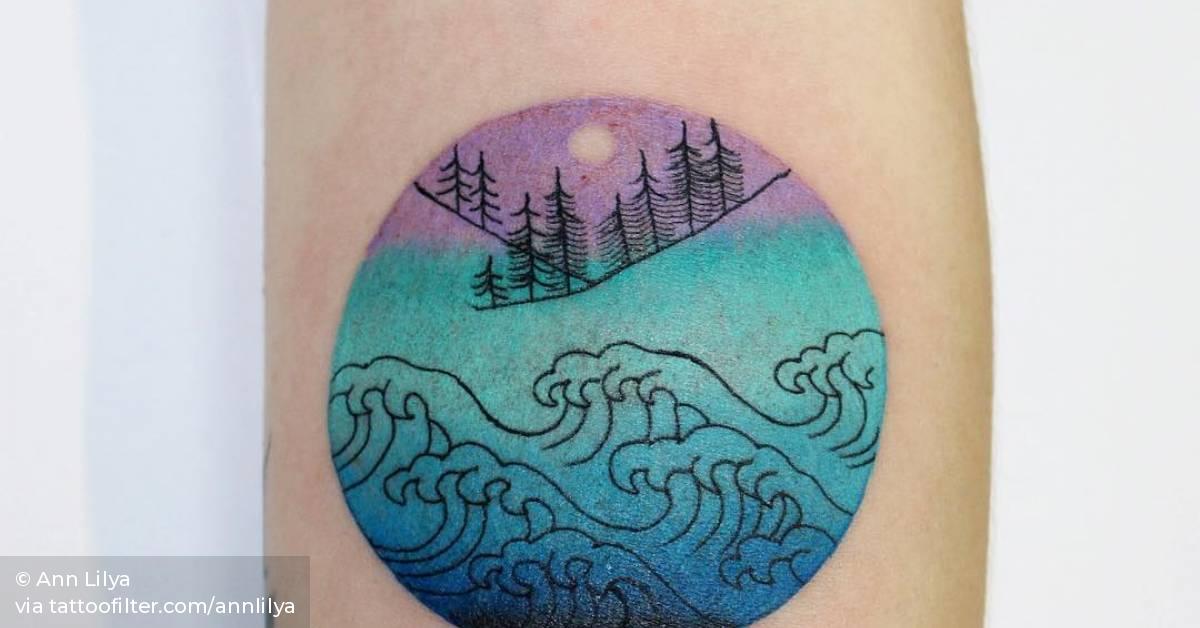 Abstract circle tattoo on the inner forearm.