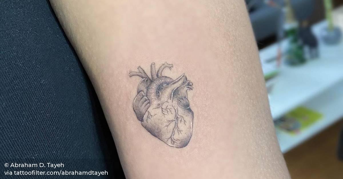 Anatomical heart tattoo on the inner forearm.