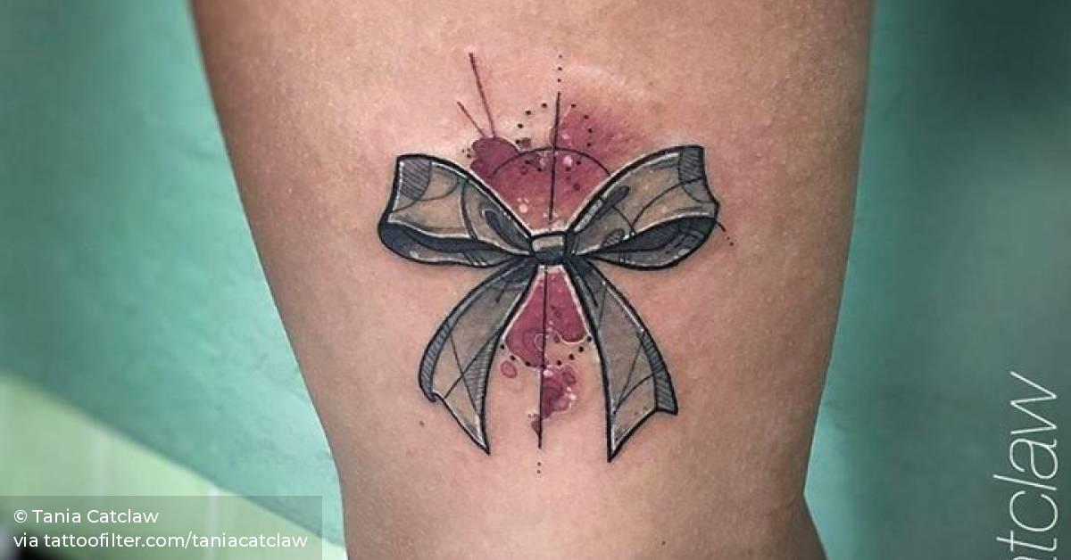 Sketch work ribbon tattoo on the upper arm.