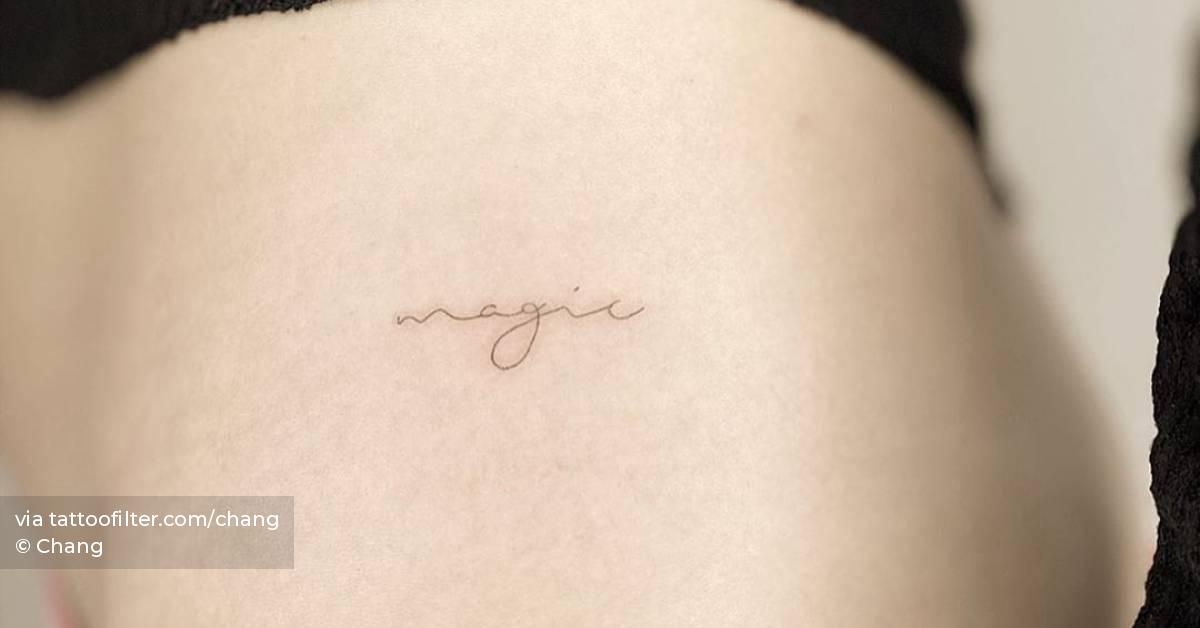 "magic" lettering tattoo on hip