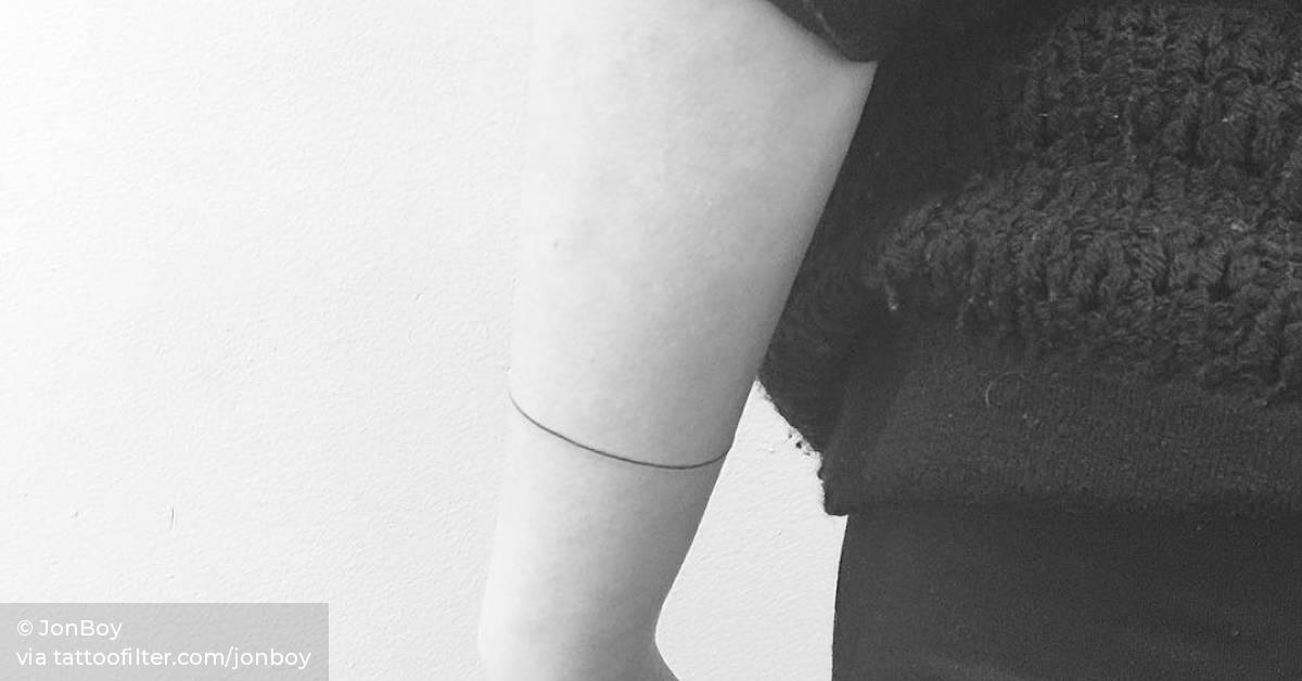 Minimalist single line armband tattoo.
