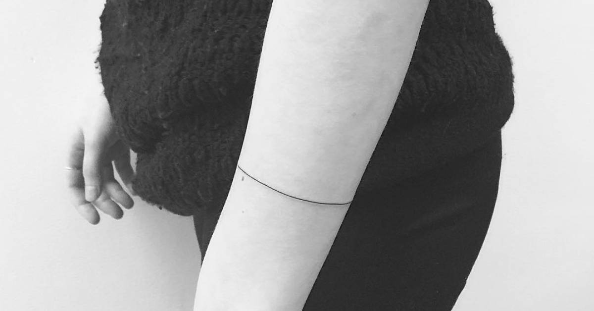 Minimalist single line armband tattoo.