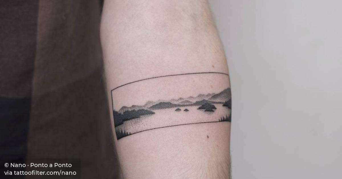 Hand poked landscape on the left inner forearm.