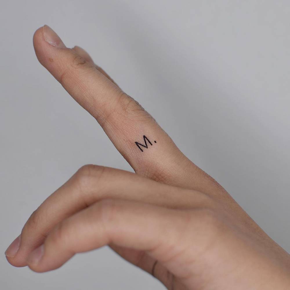Letter M Tattooed On The Finger
