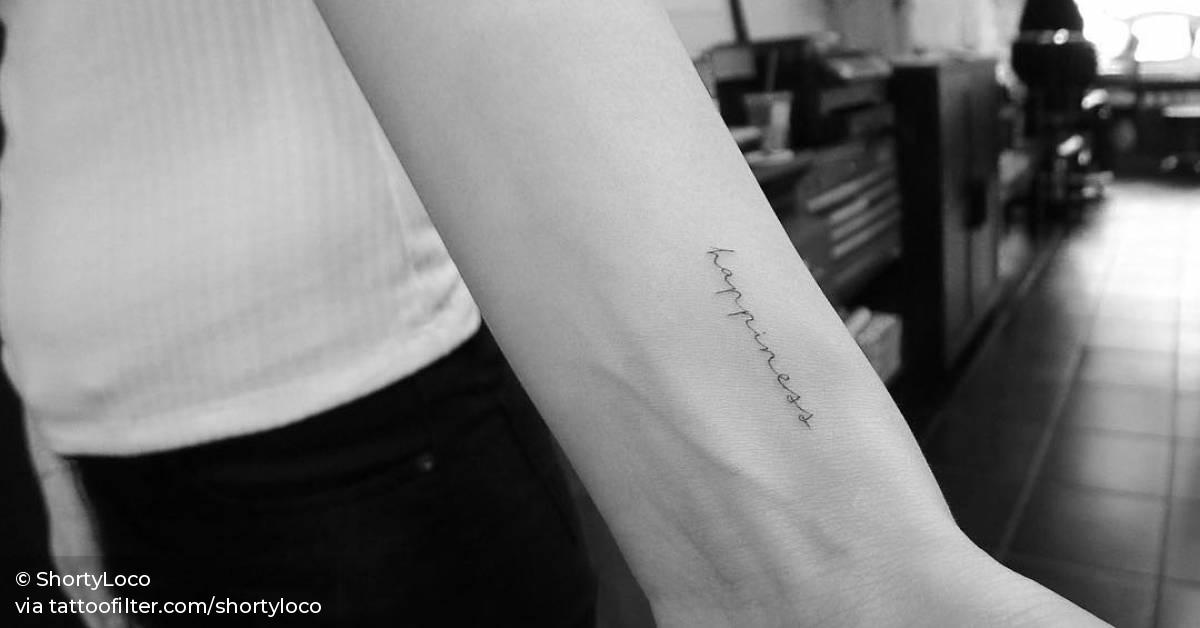 “Happiness” tattoo on the wrist.
