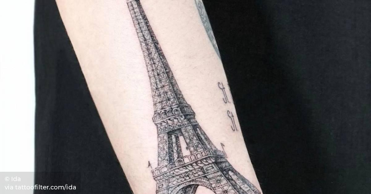 Eiffel tower tattoo on the right forearm.