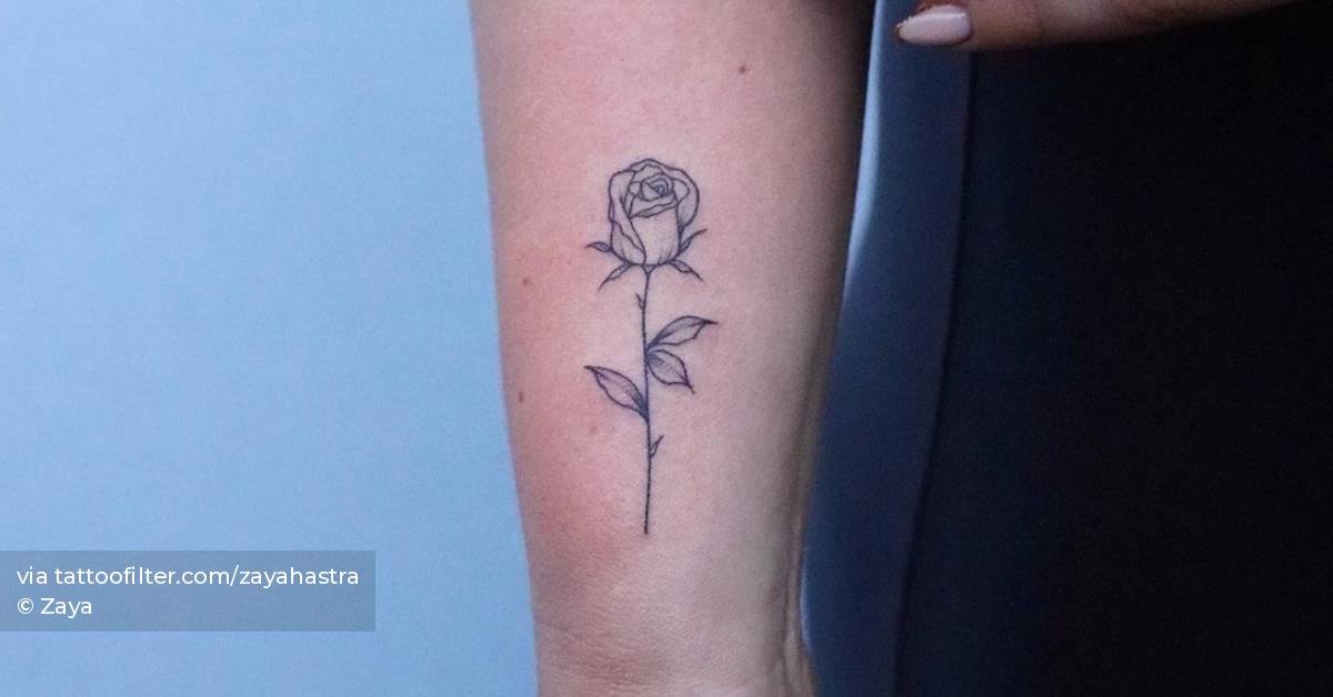 Line art rose tattoo on the wrist