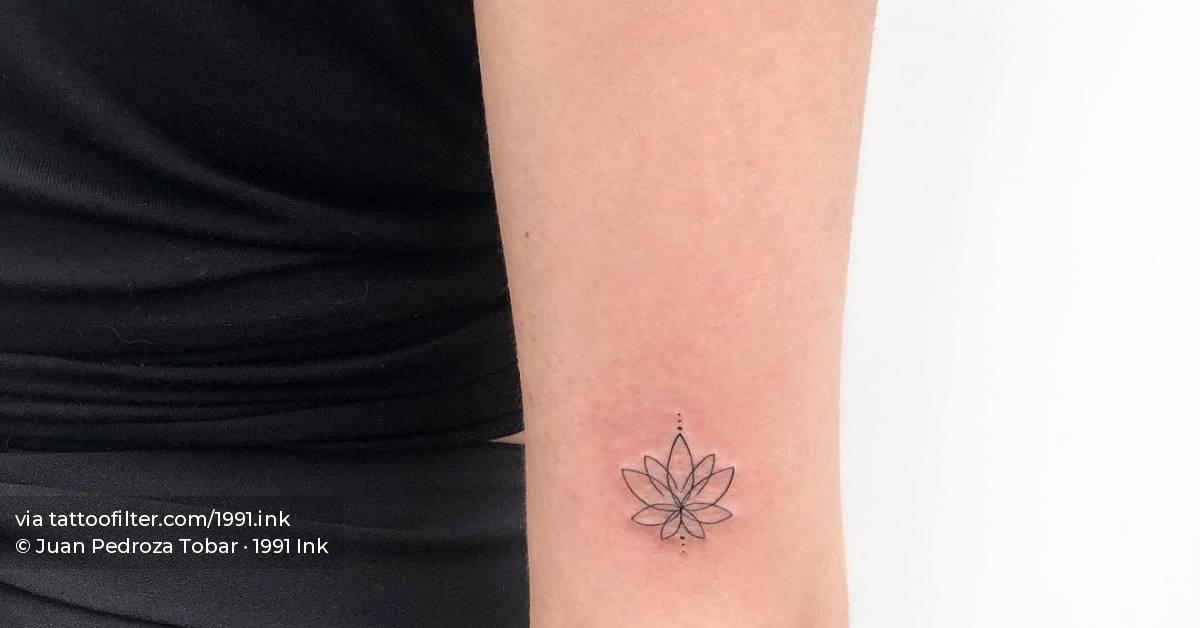 Fine line lotus flower tattoo on the tricep