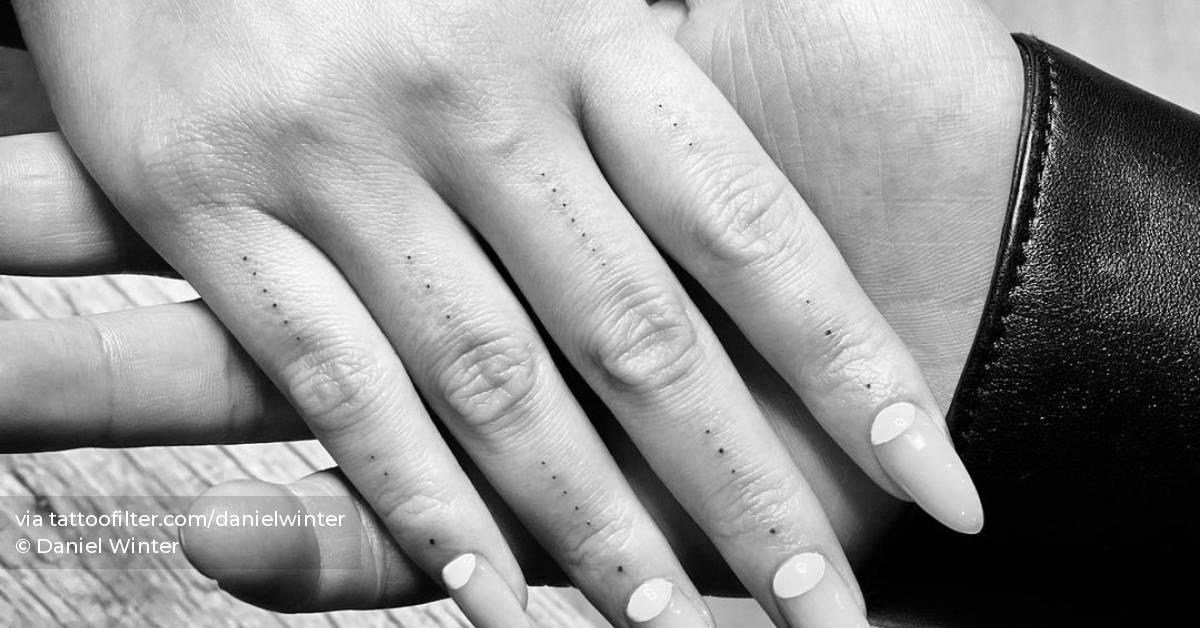 Dots tattoo on Chrissy Teigen's fingers