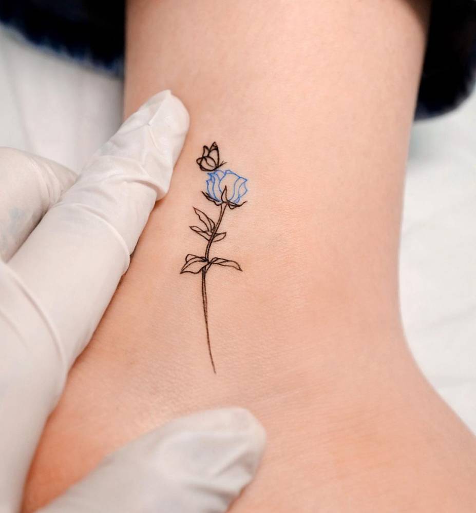 Fine line blue rose tattoo on the ankle