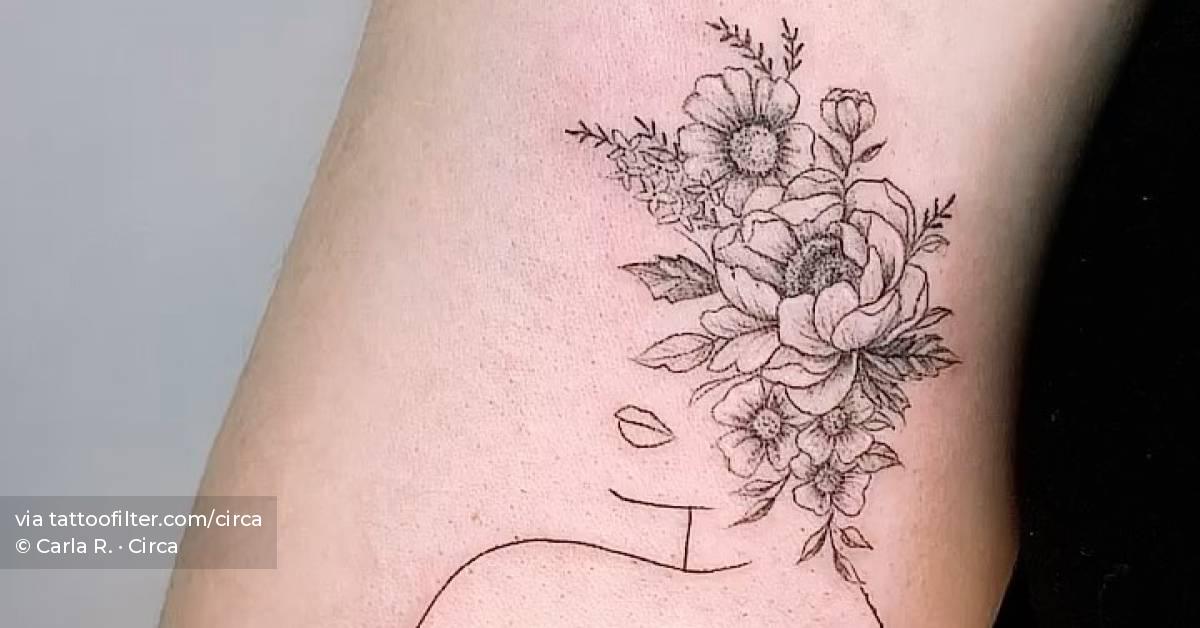 Fine line flower head woman tattoo on the inner arm