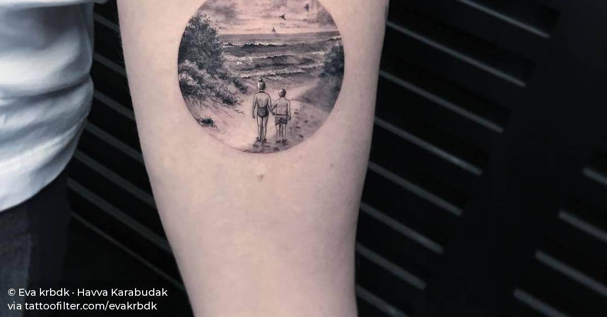 Beach landscape tattoo on the left inner forearm.