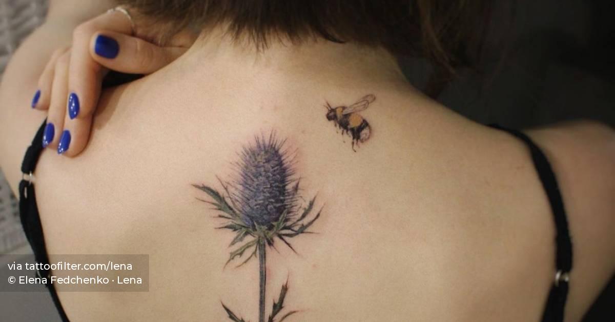 Watercolor flower and bee tattoo on the upper back.
