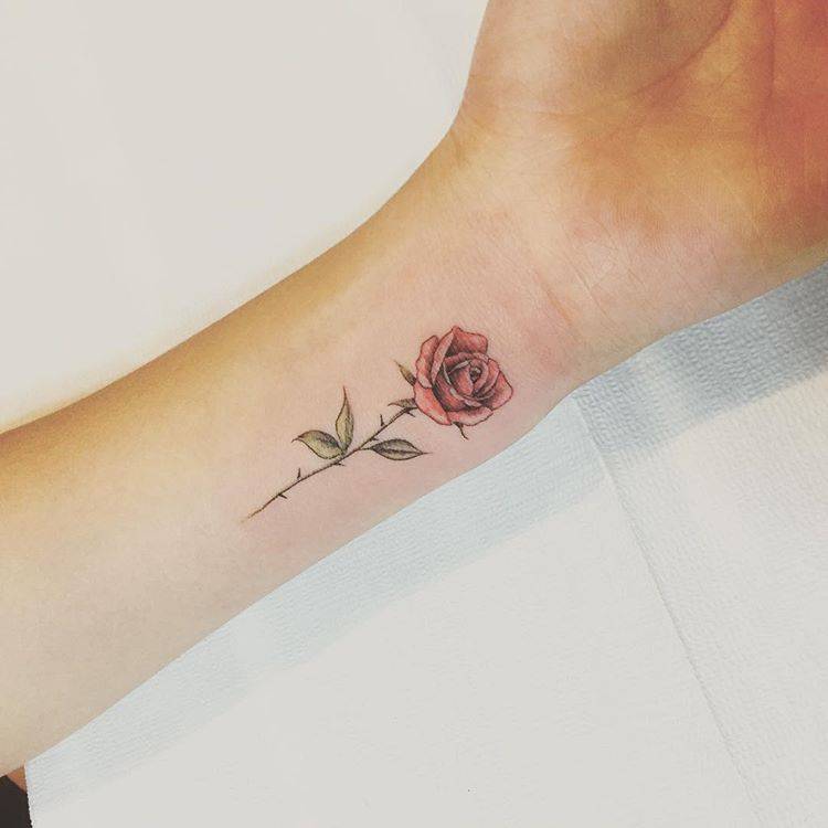 Red rose tattoo on the inner wrist.