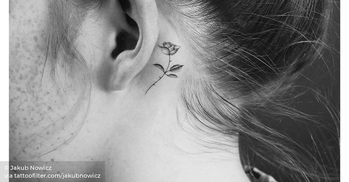 Single needle rose tattoo behind the left ear.