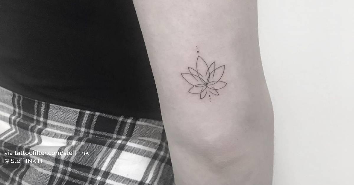 Fine line lotus flower tattoo on the tricep.