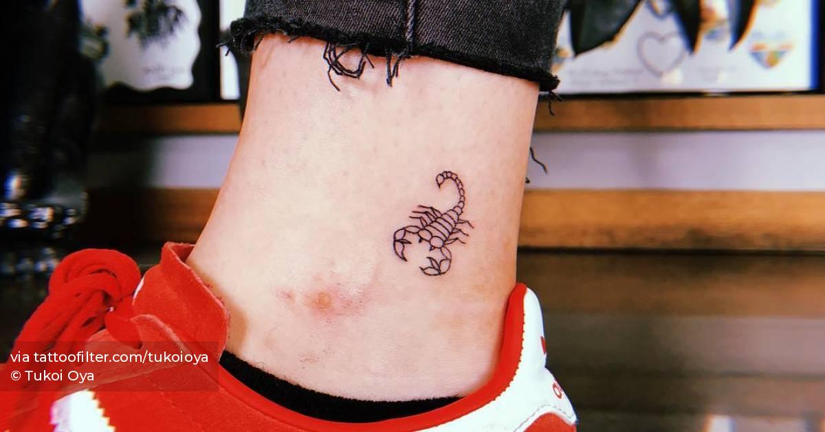 Line art scorpion tattoo on the ankle.