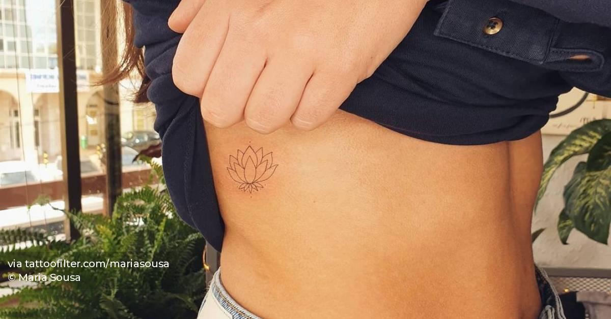 Fine line lotus flower tattoo on the rib.