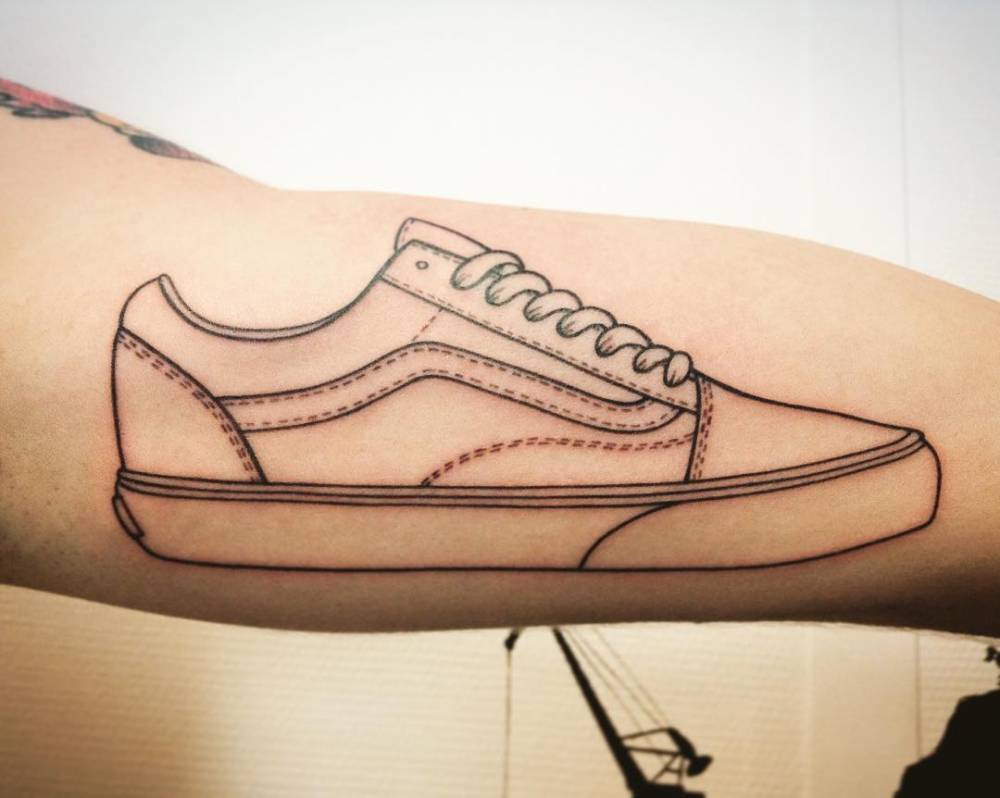 Vans Old School tattoo on the inner arm.