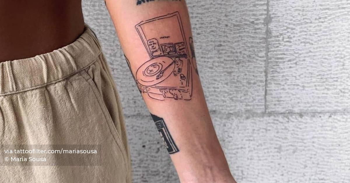 Fine line turntable tattoo on the inner forearm.