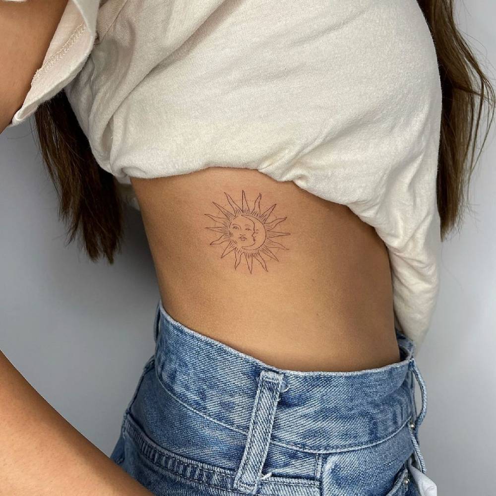 FIne line sun and moon tattoo on the rib.