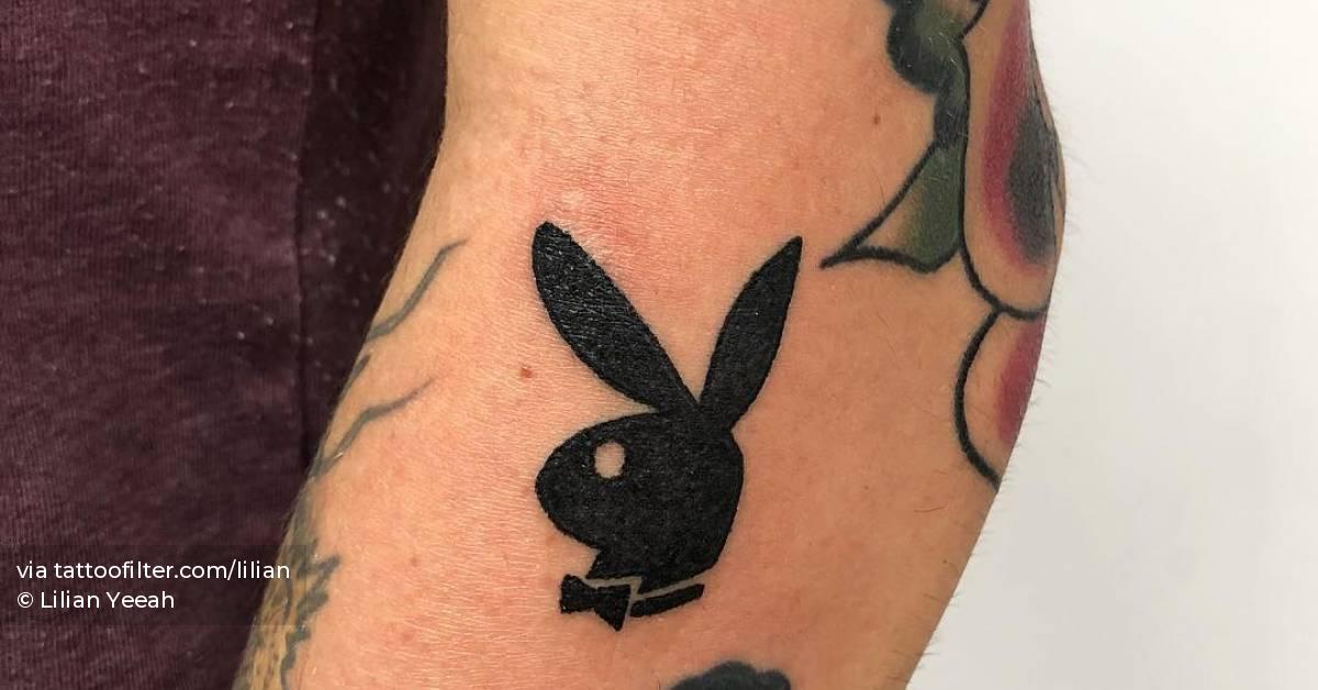 Hand poked Playboy logo tattoo on the forearm.