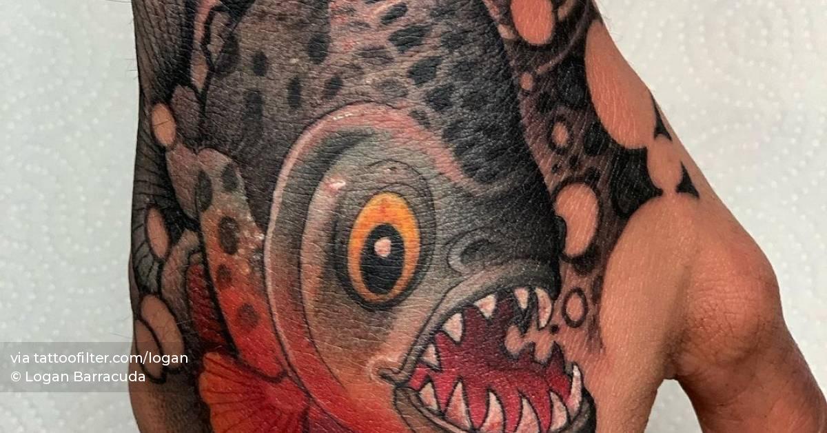 New School piranha tattoo on the hand.